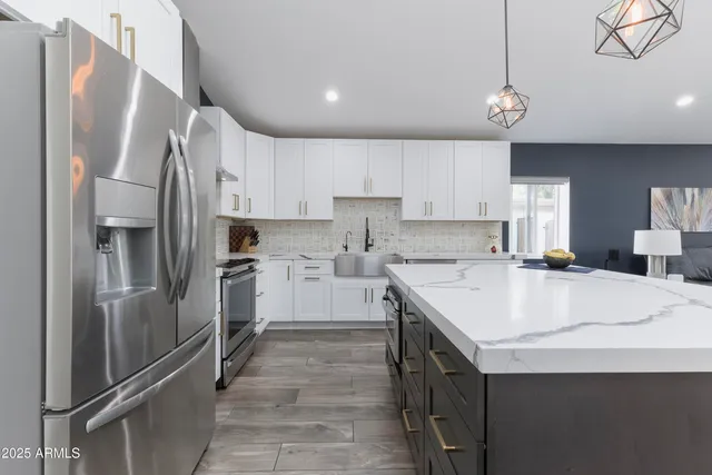 a kitchen with a sink stainless steel appliances and cabinets