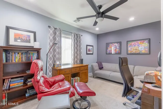 a living room with furniture a rug and a window