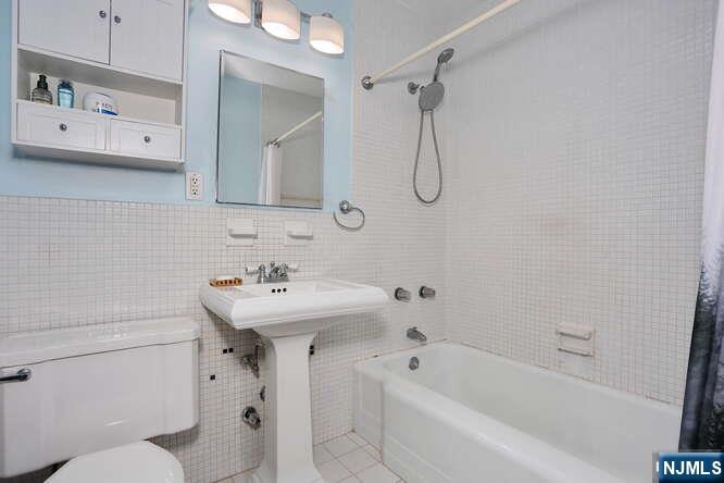 2 Horizon Road, Unit 404 Fort Lee, NJ 07024 - Photo 16 of 30 a bathroom with a sink a toilet and shower
