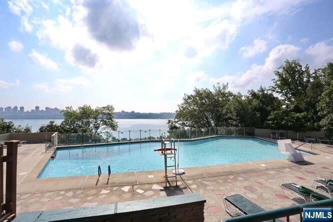 2 Horizon Road, Unit 404 Fort Lee, NJ 07024 - Photo 26 of 30 a view of a swimming pool with a yard