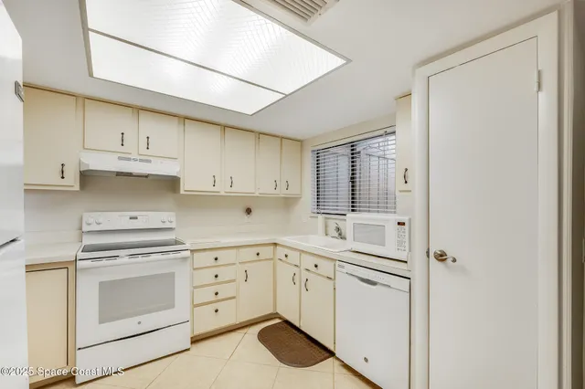a kitchen with appliances cabinets and a sink