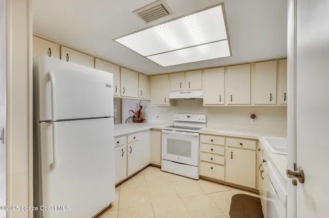 a kitchen with stainless steel appliances a refrigerator sink and cabinets