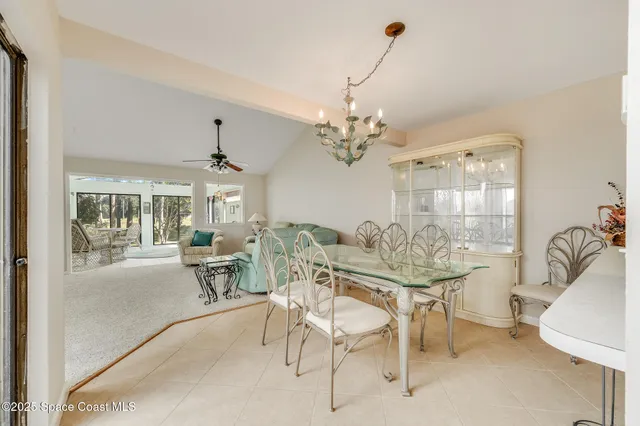 a view of a dining room with furniture and a chandelier