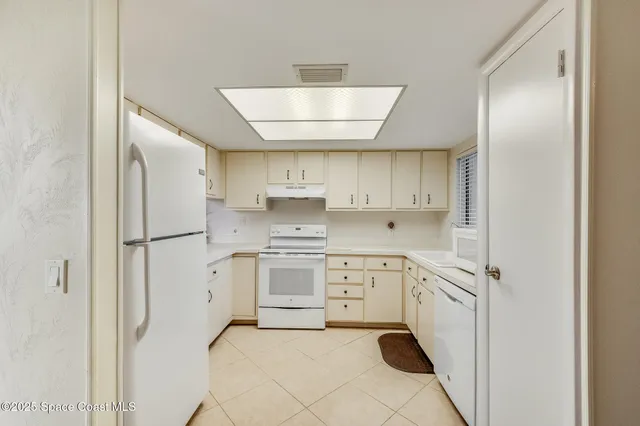 a kitchen with stainless steel appliances a refrigerator sink and stove