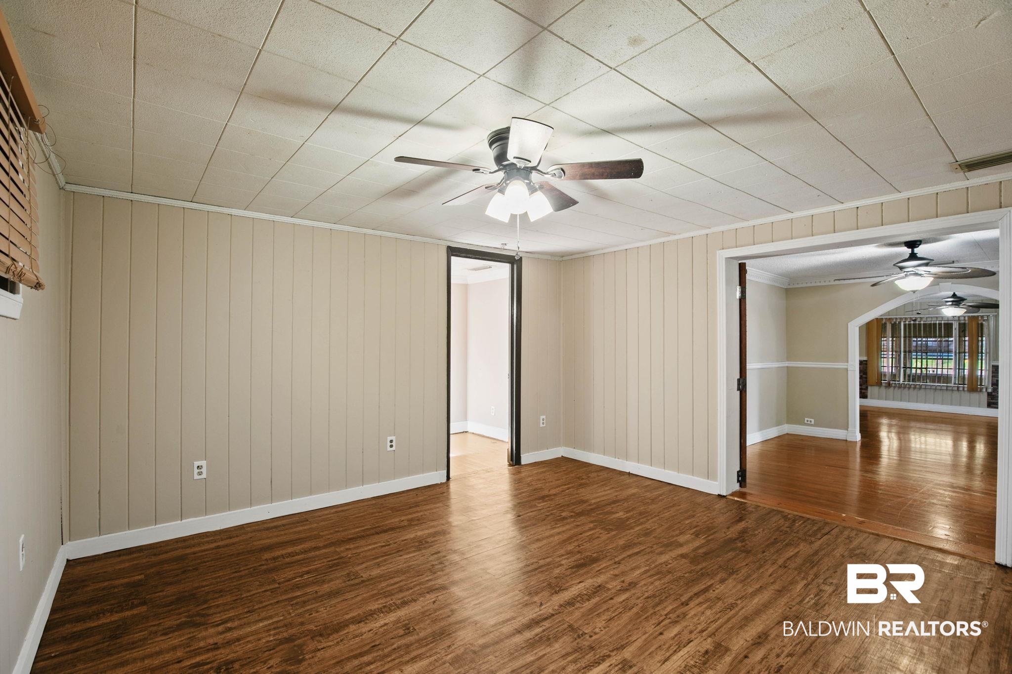 23240 County Road 47 Perdido, AL 36562 - Photo 12 of 29 Empty room with ceiling fan, dark wood-style flooring, wood walls, and crown molding