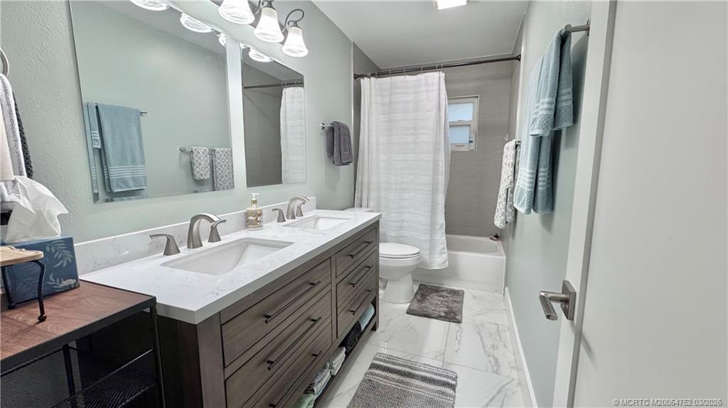 323 Southwest Ridge Lane Stuart, FL 34994 - Photo 11 of 22 a spacious bathroom with a double vanity sink toilet and shower