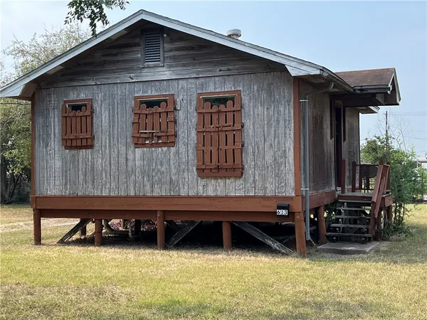 a backyard of a house with barbeque oven and table