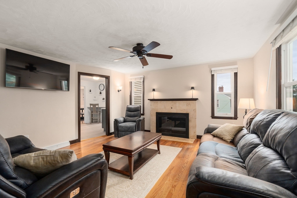 9 Laurel Lane Bellingham, MA 02019 - Photo 19 of 30 a living room with furniture a flat screen tv and a fireplace