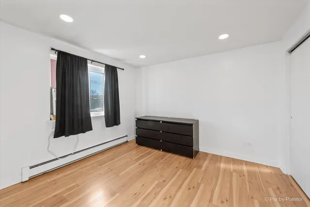 a room with a wooden floor and a window