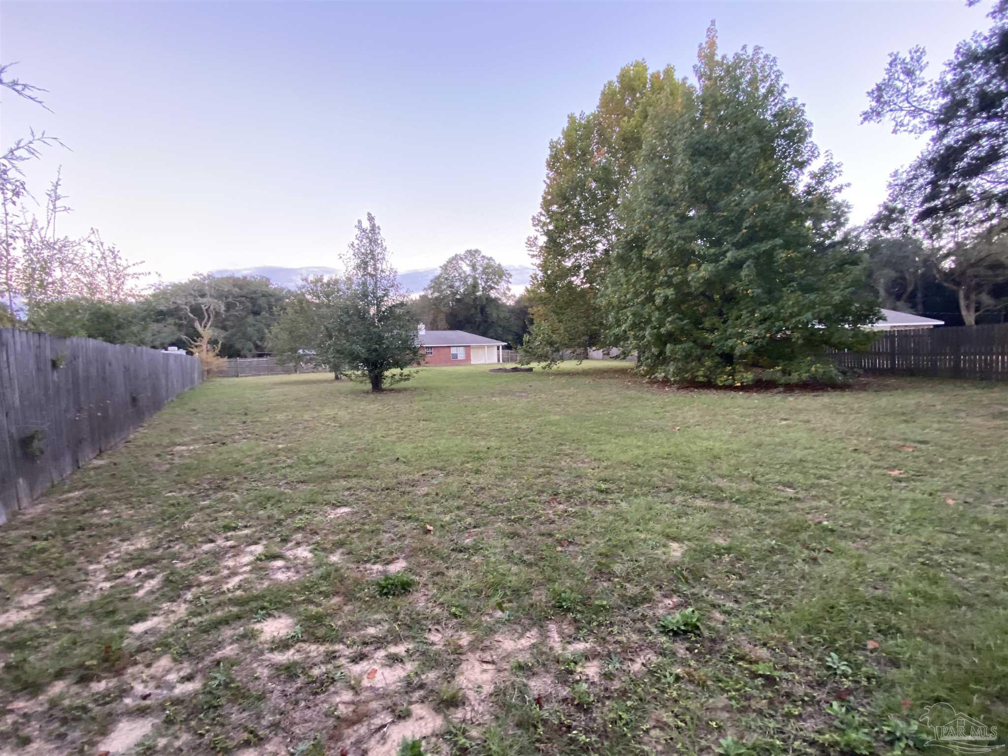 5493 Riviera Drive Milton, FL 32583 - Photo 17 of 21 a view of an outdoor space and a yard