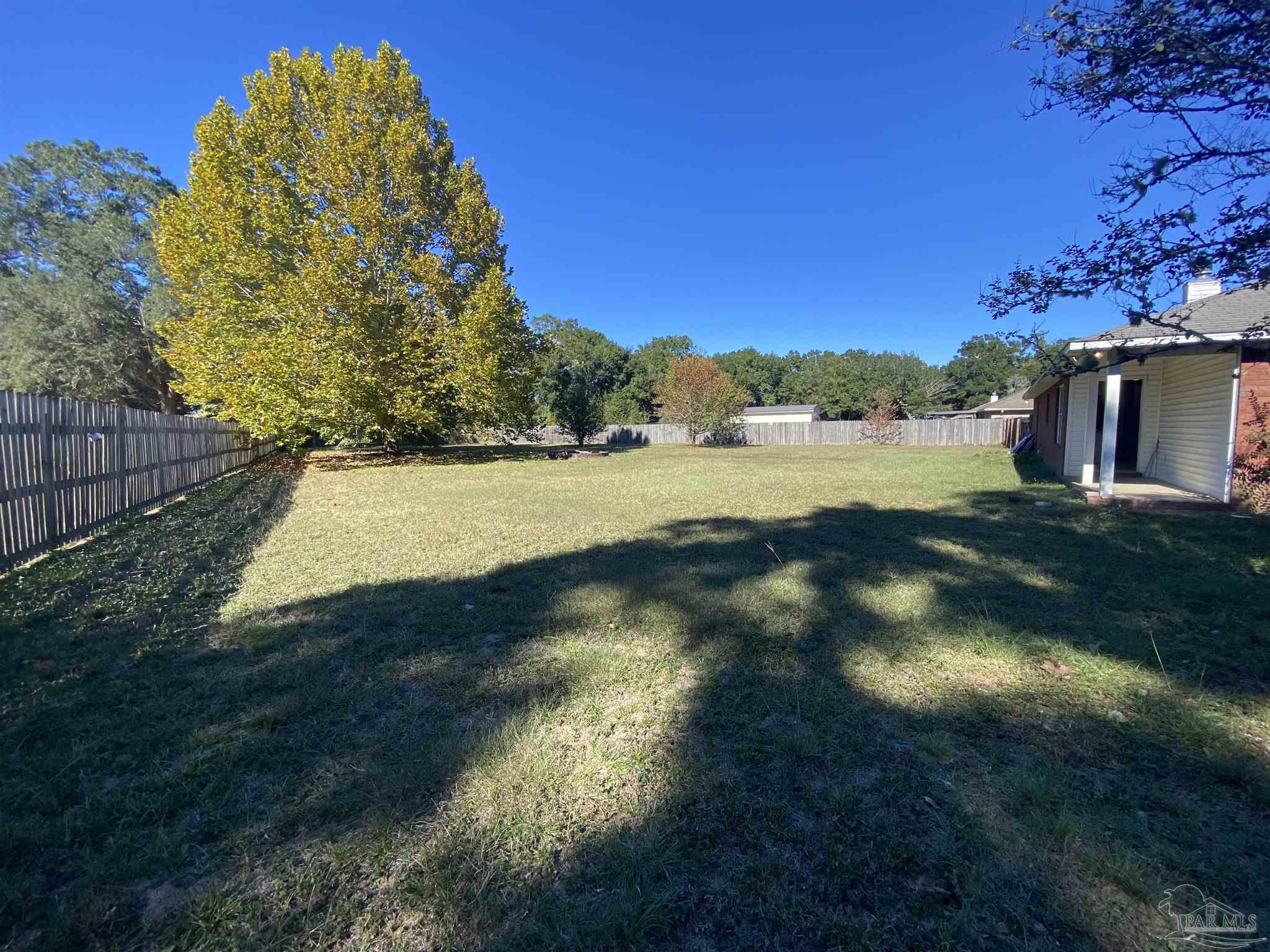 5493 Riviera Drive Milton, FL 32583 - Photo 18 of 21 a view of an outdoor space and a yard
