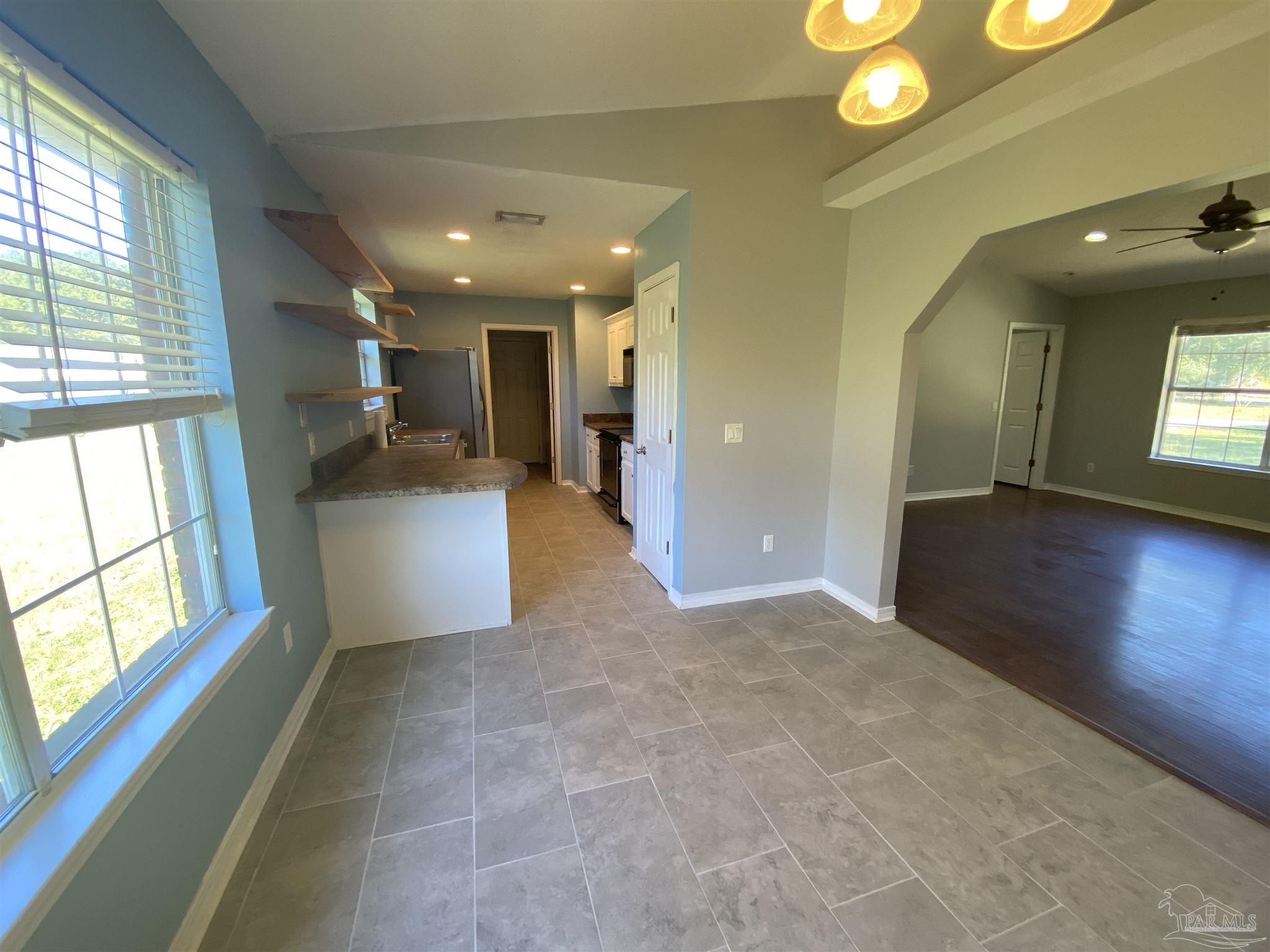 5493 Riviera Drive Milton, FL 32583 - Photo 7 of 21 a view of hallway with furniture and a chandelier