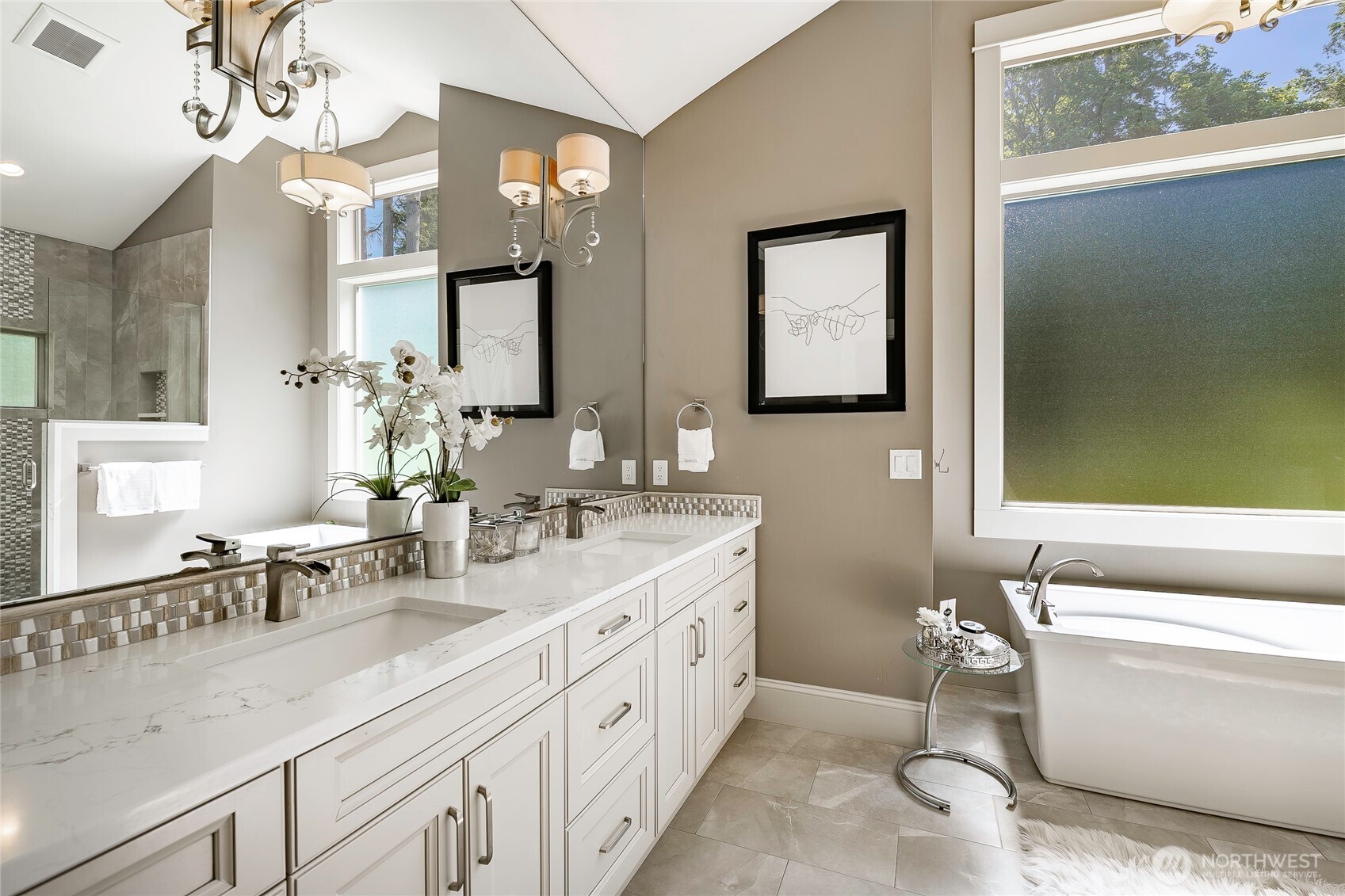 9125 Shearwater Road Blaine, WA 98230 - Photo 22 of 40 a bathroom with a double vanity sink a mirror and a bathtub