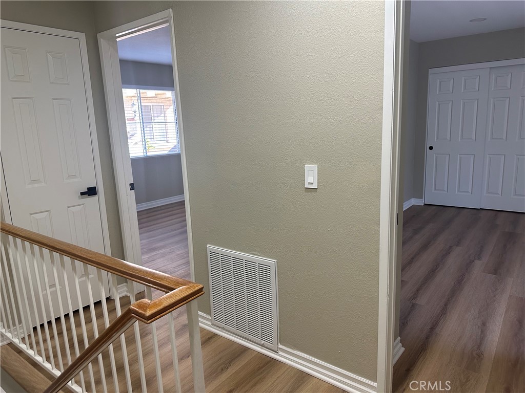 201 Laurel Avenue, Unit 6 Brea, CA 92821 - Photo 20 of 24 a view of a hallway with wooden floor and staircase