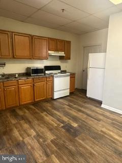 21614 Great Mills Road, Unit 104 Lexington Park, MD 20653 - Photo 16 of 17 a kitchen with stainless steel appliances granite countertop a stove a sink and a refrigerator