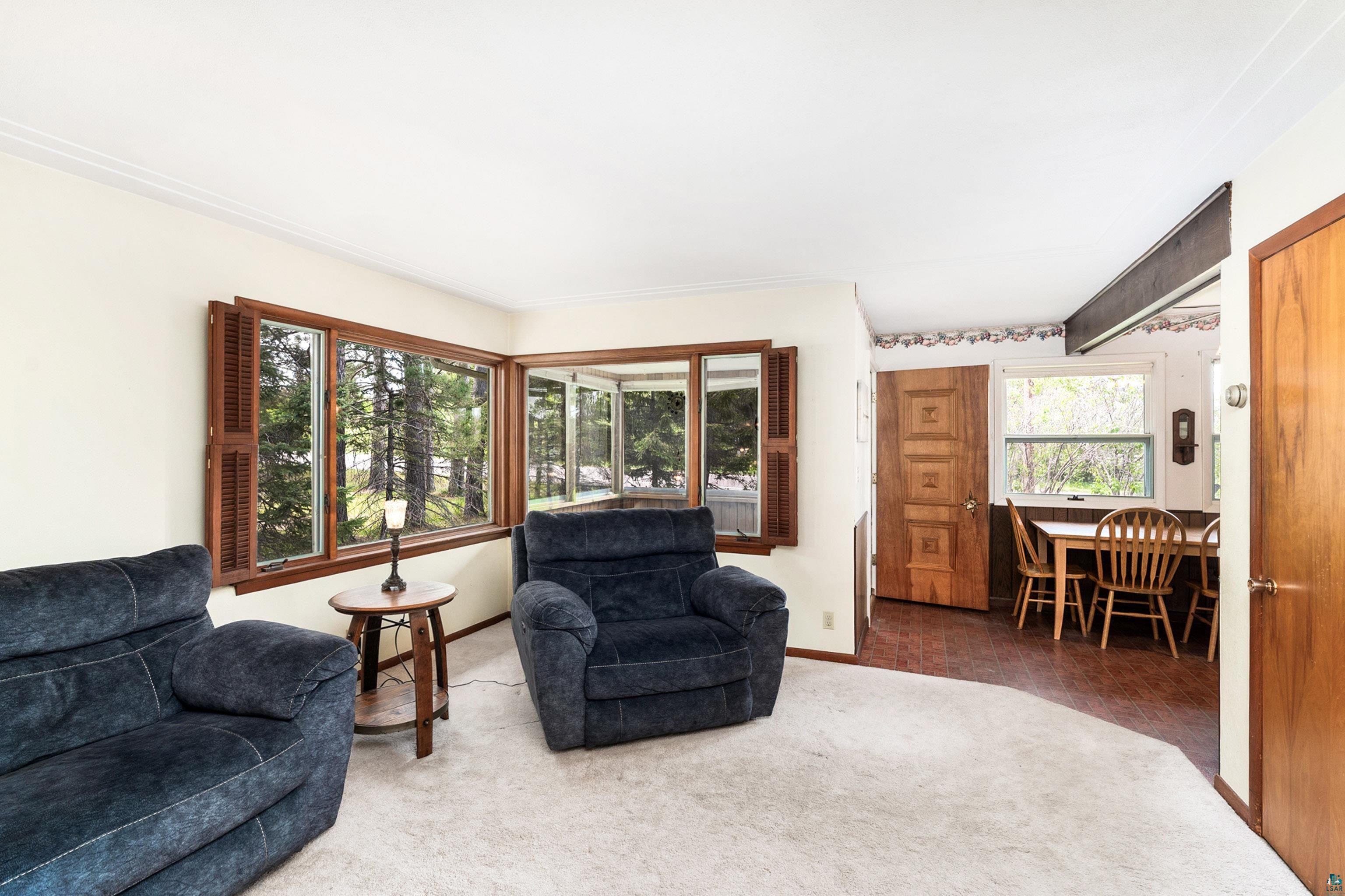 4808 Midway Road Duluth, MN 55811 - Photo 16 of 57 Living area featuring a bay window with wood-frame windows and interior wood shutters