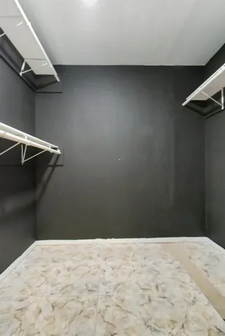 wooden floor in an empty room with a bathroom