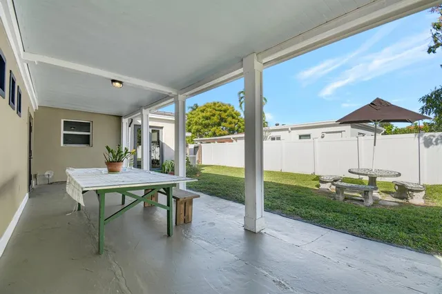 a front view of a house with a yard table and chairs
