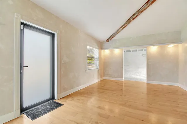 a view of an empty room with glass door