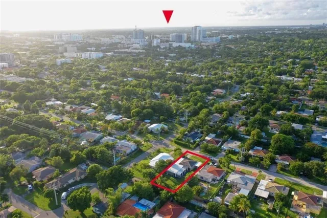 a front view of house with yard and trees in the background