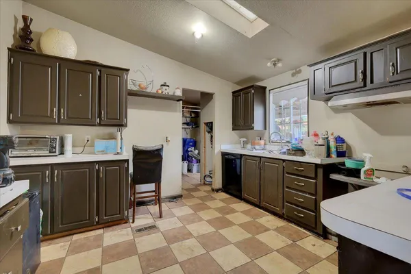 a kitchen with a sink stove and cabinets