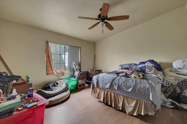 a bedroom with a bed and window