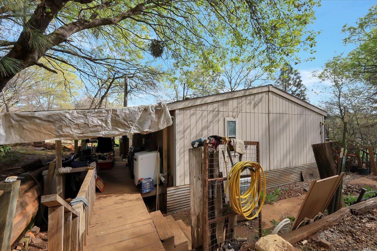 10447 Texas Hill Road Dobbins, CA 95935 - Photo 26 of 55 a view of a patio with table and chairs under an umbrella