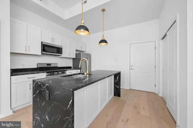 an empty room with windows and closet