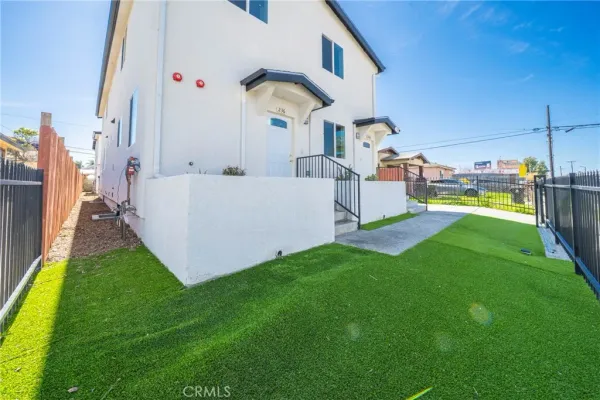 a view of a house with a yard and sitting area