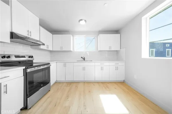 a view of a kitchen with electric appliances