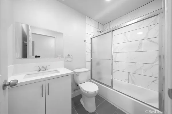 a bathroom with a toilet sink and shower