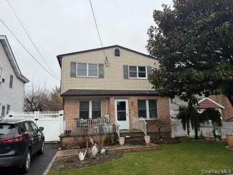 a front view of house with yard outdoor seating and green space