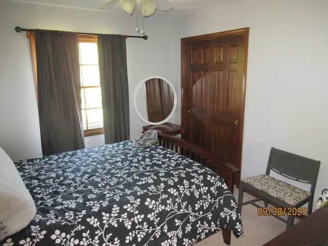 a bedroom with a bed and a window