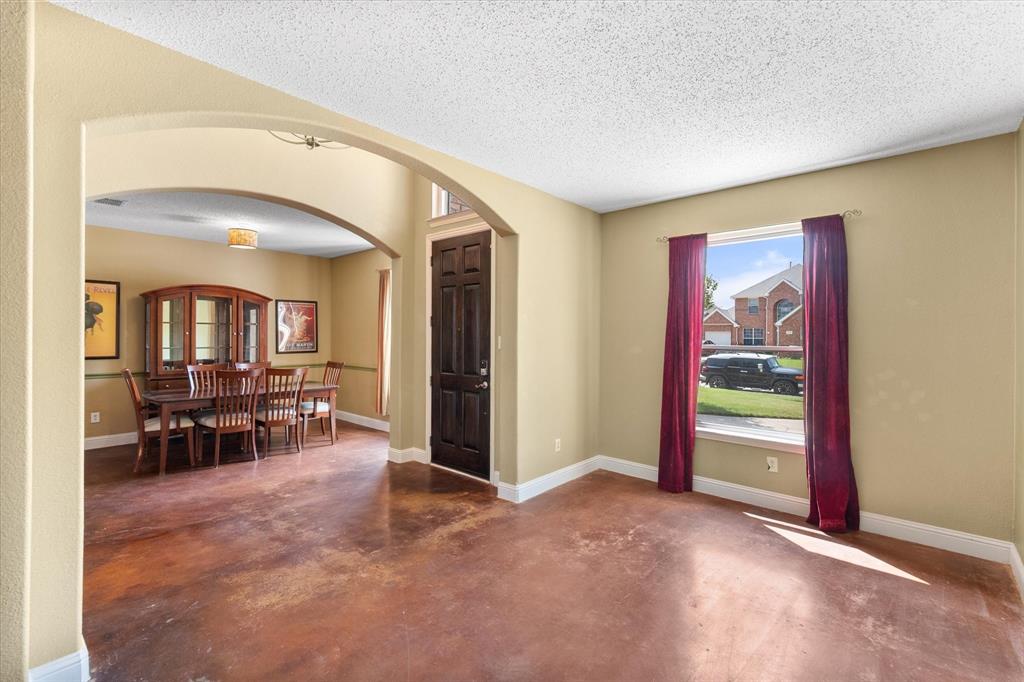 1305 Liverpool Lane Mansfield, TX 76063 - Photo 4 of 40 This inviting interior features a spacious room with stained concrete flooring and a prominent window