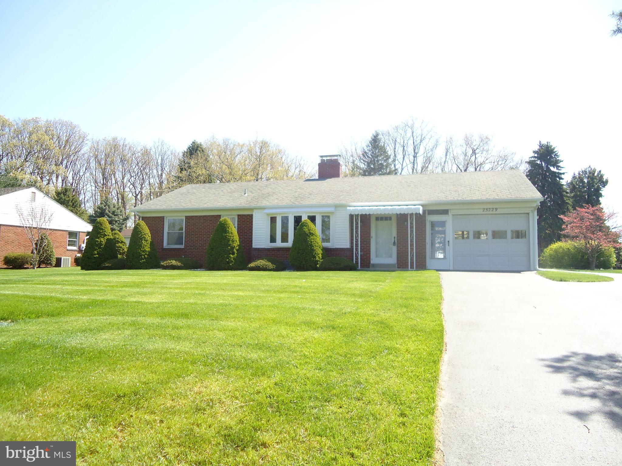 25229 Woodfield Road Damascus, MD 20872 - Photo 1 of 30 a front view of a house with a garden