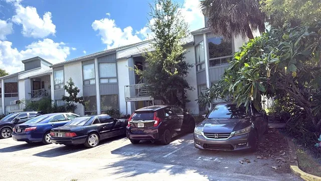 a couple of cars parked in front of a house