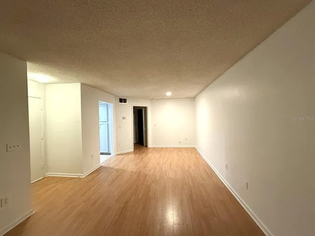 a view of an empty room and wooden floor