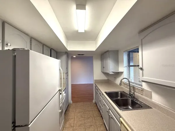 a kitchen with a refrigerator and a sink