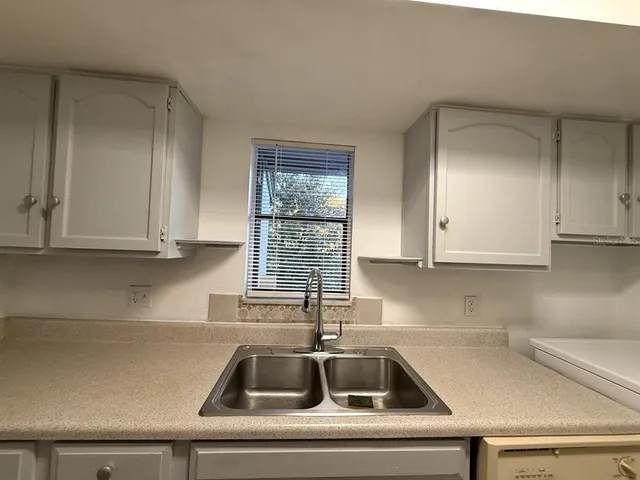 a kitchen with a sink and cabinets