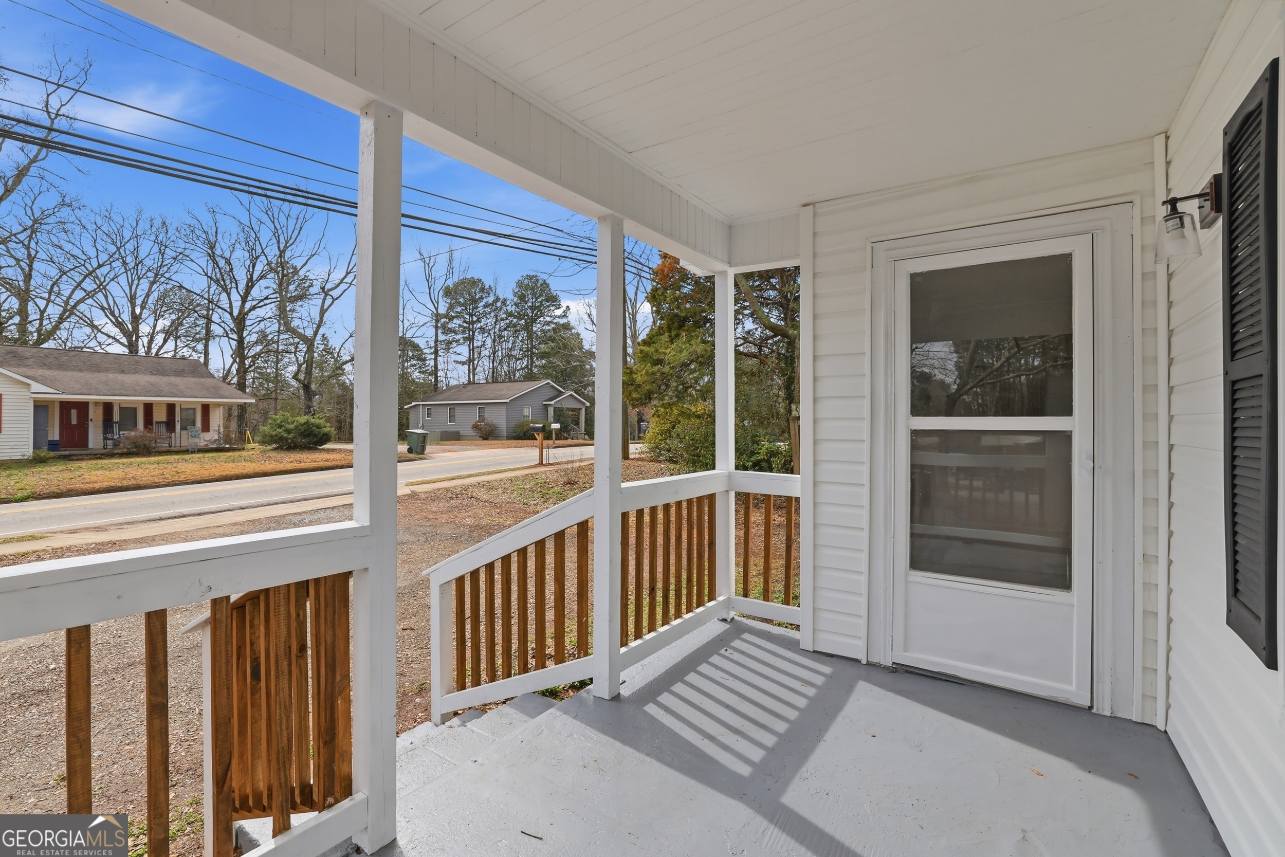 481 Collins Road Toccoa, GA 30577 - Photo 14 of 54 a view of a balcony with wooden floor and door