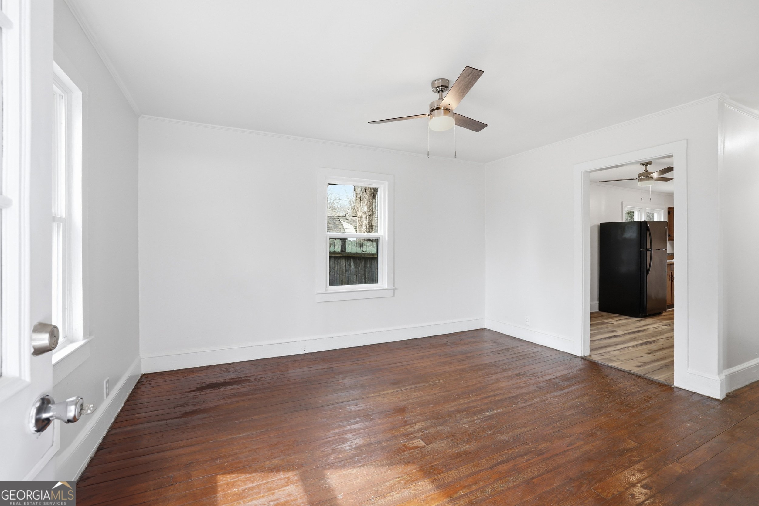 481 Collins Road Toccoa, GA 30577 - Photo 16 of 54 a view of an empty room with wooden floor and a window