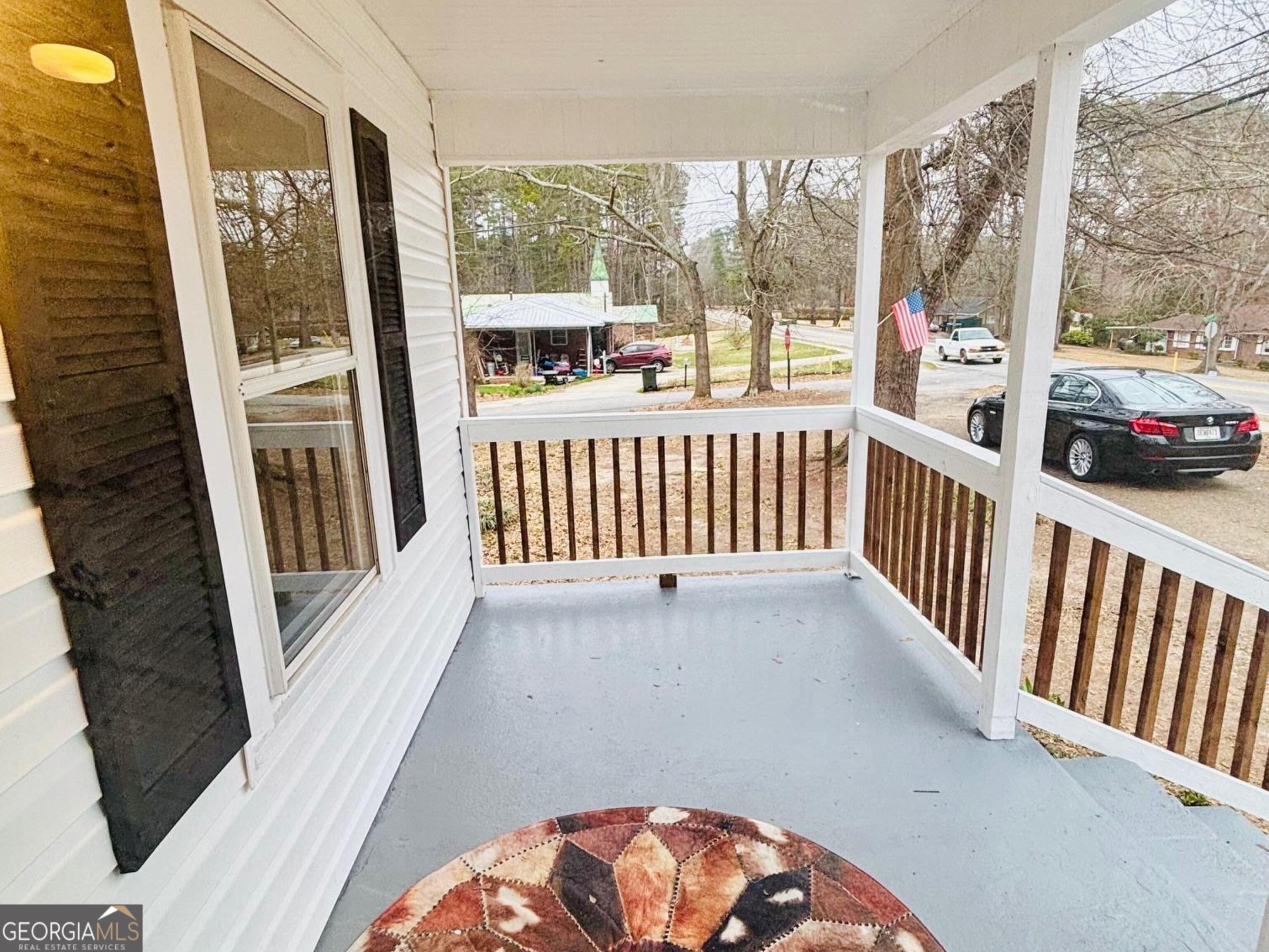 481 Collins Road Toccoa, GA 30577 - Photo 17 of 54 a view of a porch with wooden floor and furniture