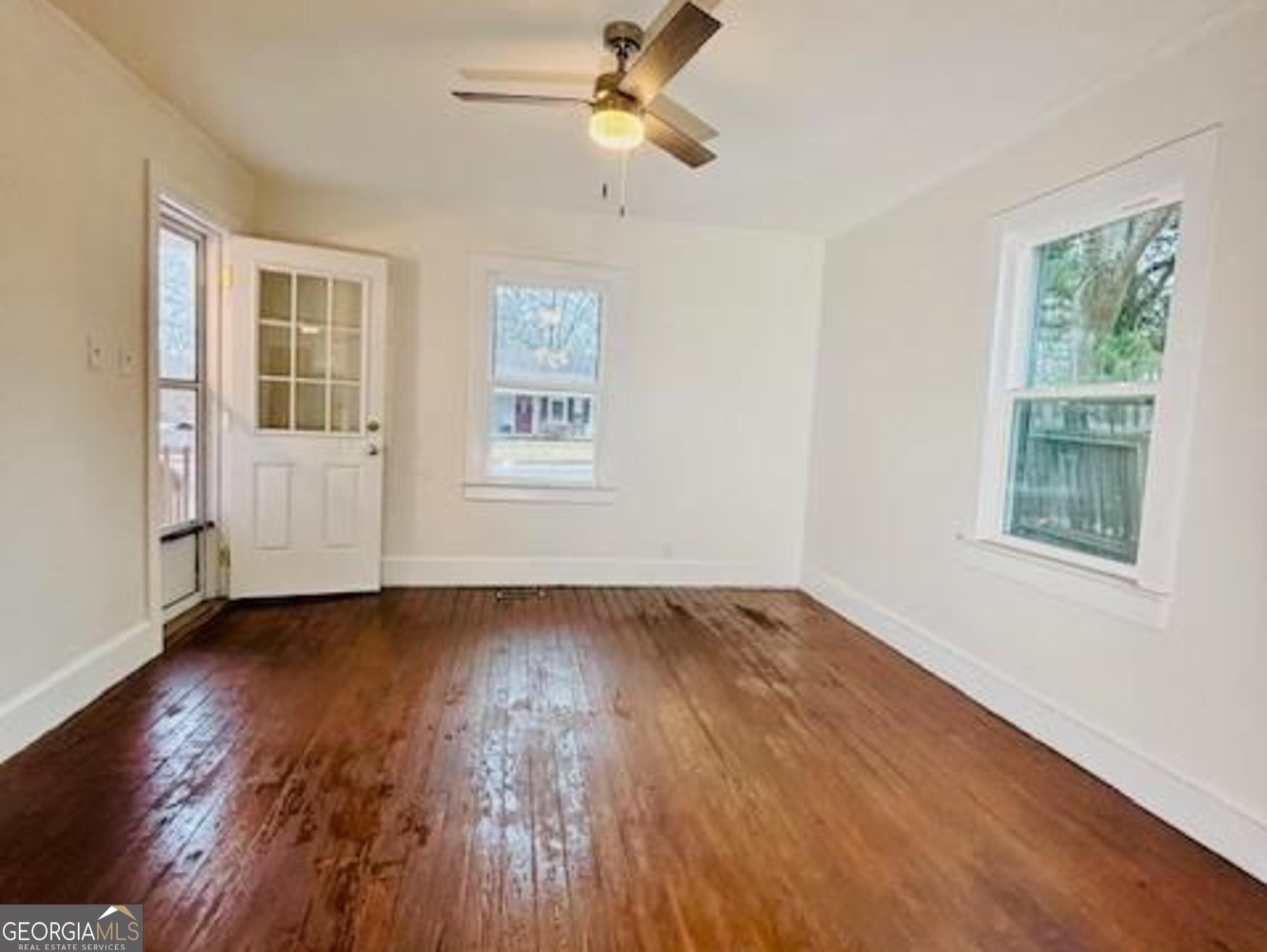 481 Collins Road Toccoa, GA 30577 - Photo 19 of 54 a view of an empty room with wooden floor and a window