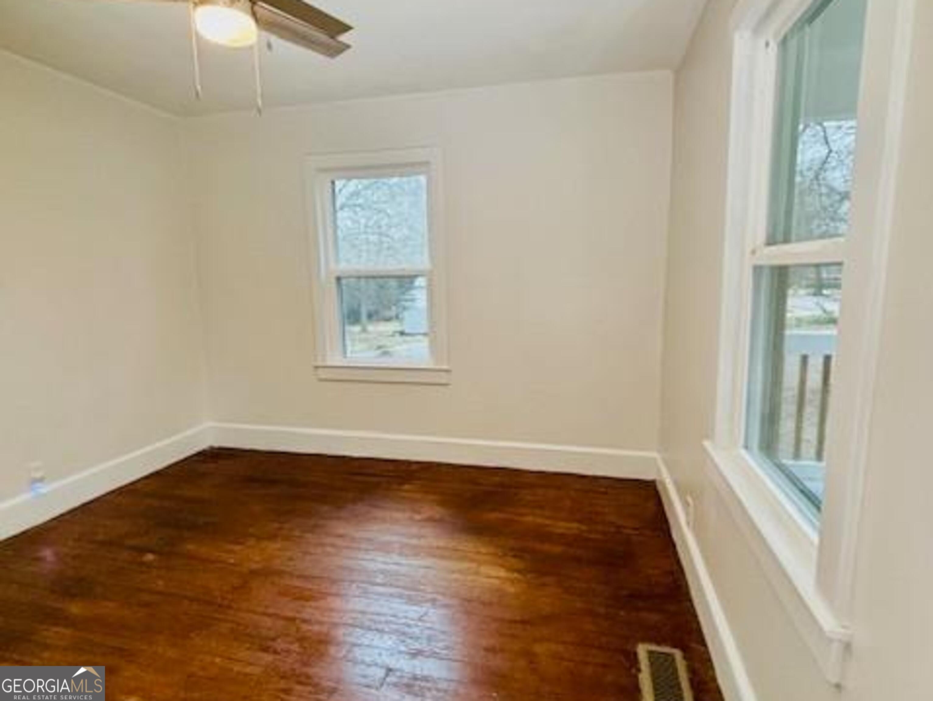 481 Collins Road Toccoa, GA 30577 - Photo 21 of 54 a view of an empty room with wooden floor and a window
