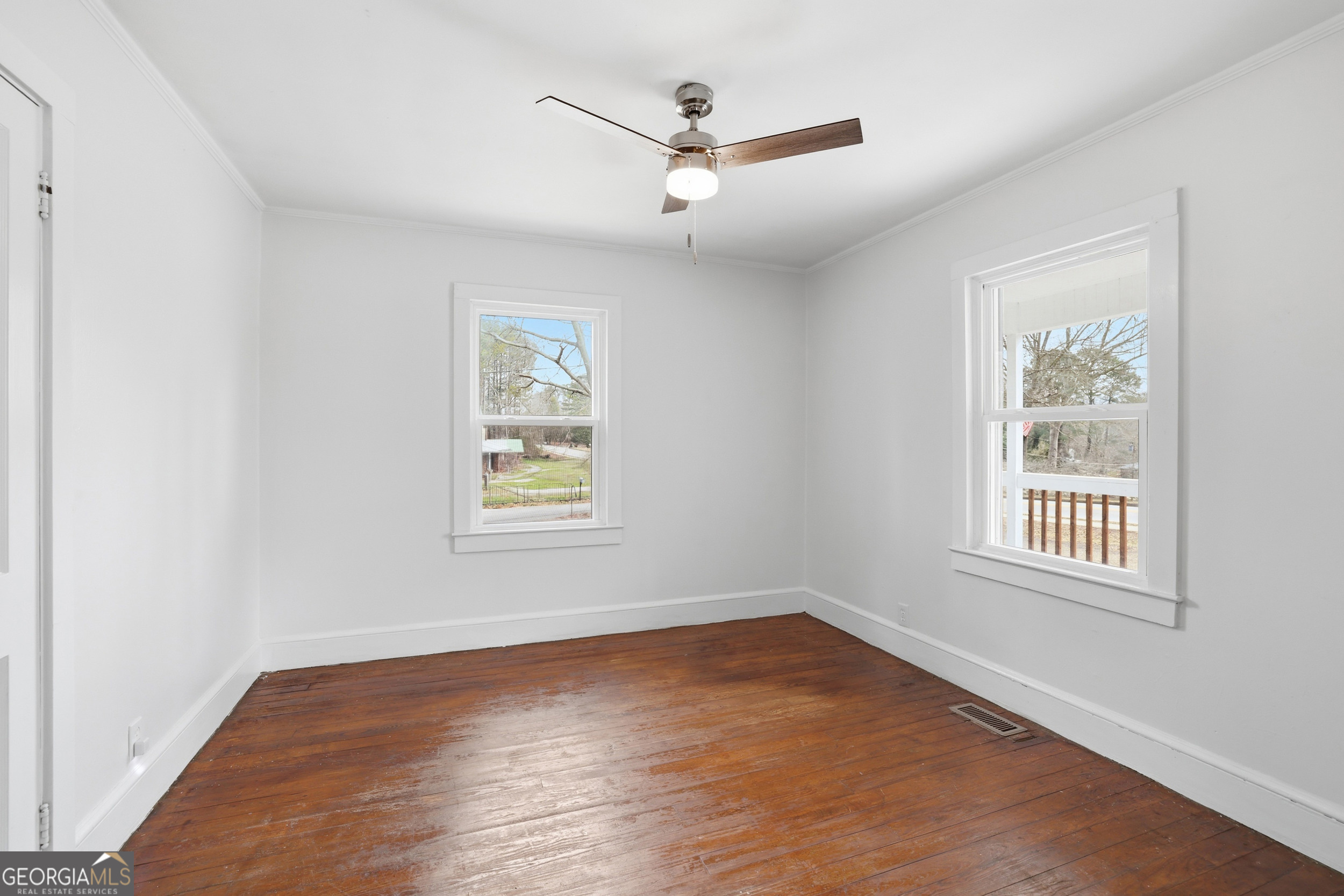 481 Collins Road Toccoa, GA 30577 - Photo 22 of 54 a view of an empty room with a window and wooden floor