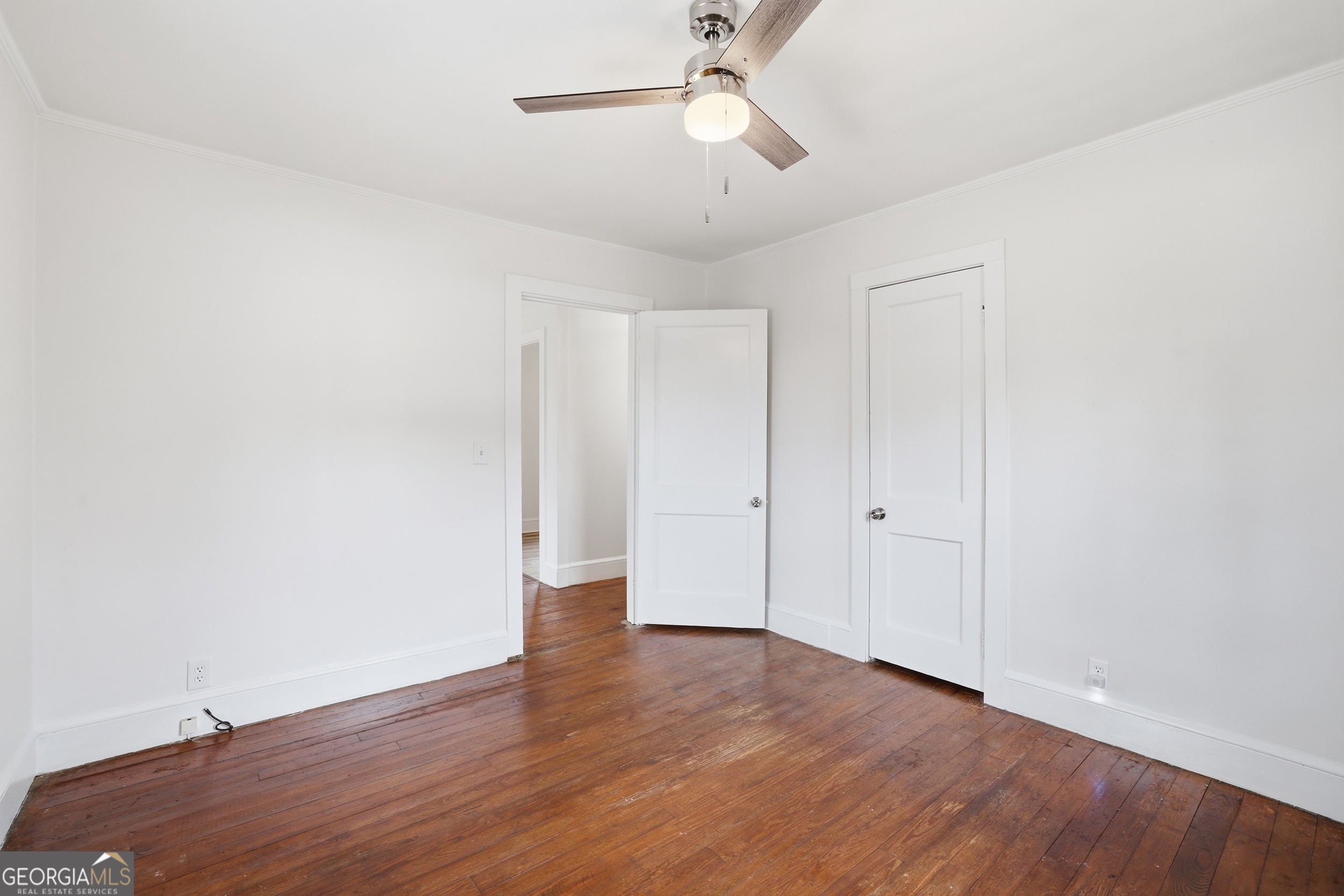 481 Collins Road Toccoa, GA 30577 - Photo 24 of 54 an empty room with wooden floor and ceiling fan