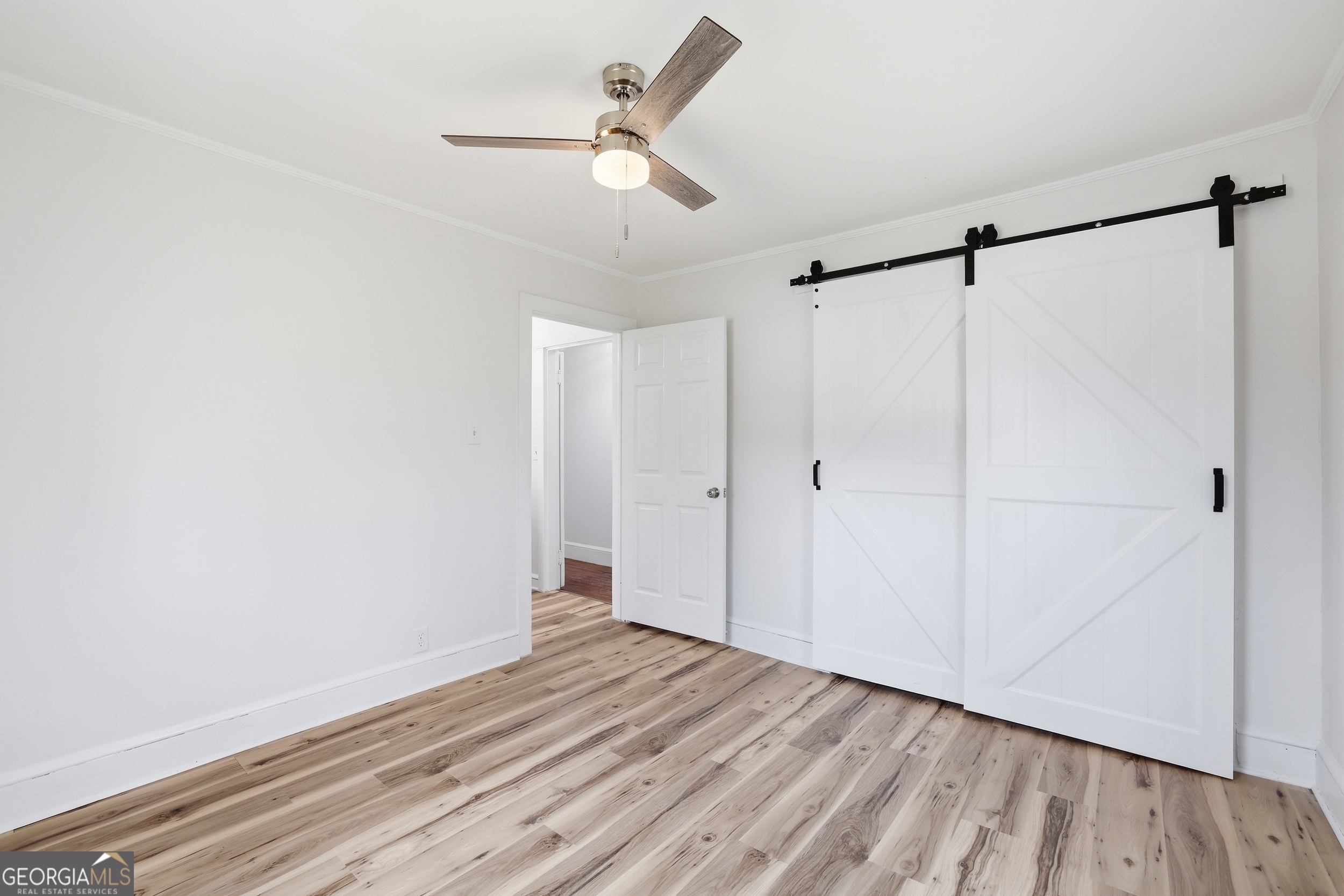 481 Collins Road Toccoa, GA 30577 - Photo 30 of 54 a view of a room with wooden floor closet and ceiling fan