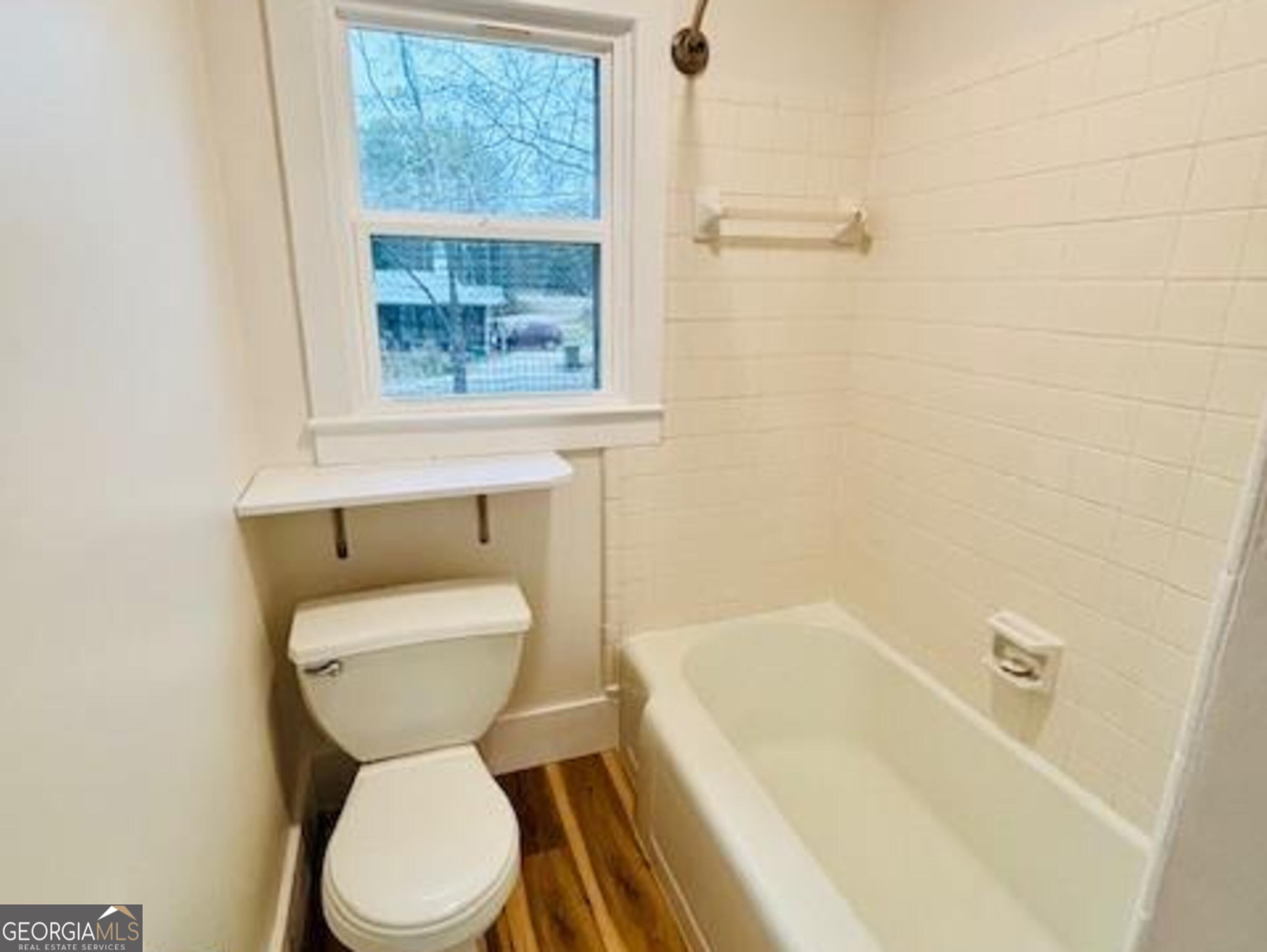 481 Collins Road Toccoa, GA 30577 - Photo 33 of 54 a bathroom with a toilet and a bathtub