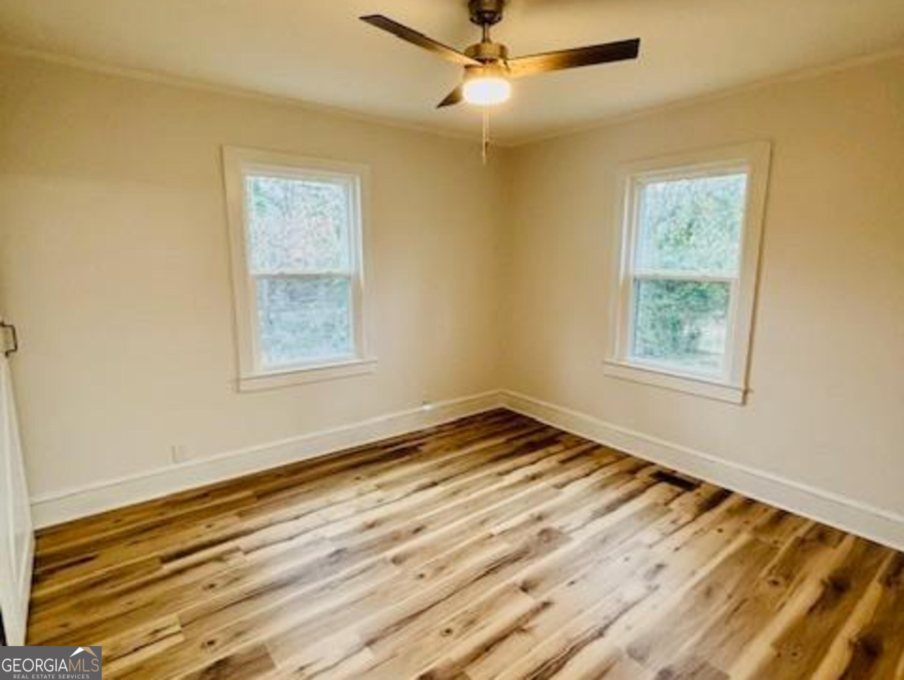 481 Collins Road Toccoa, GA 30577 - Photo 35 of 54 a view of an empty room with wooden floor and a window
