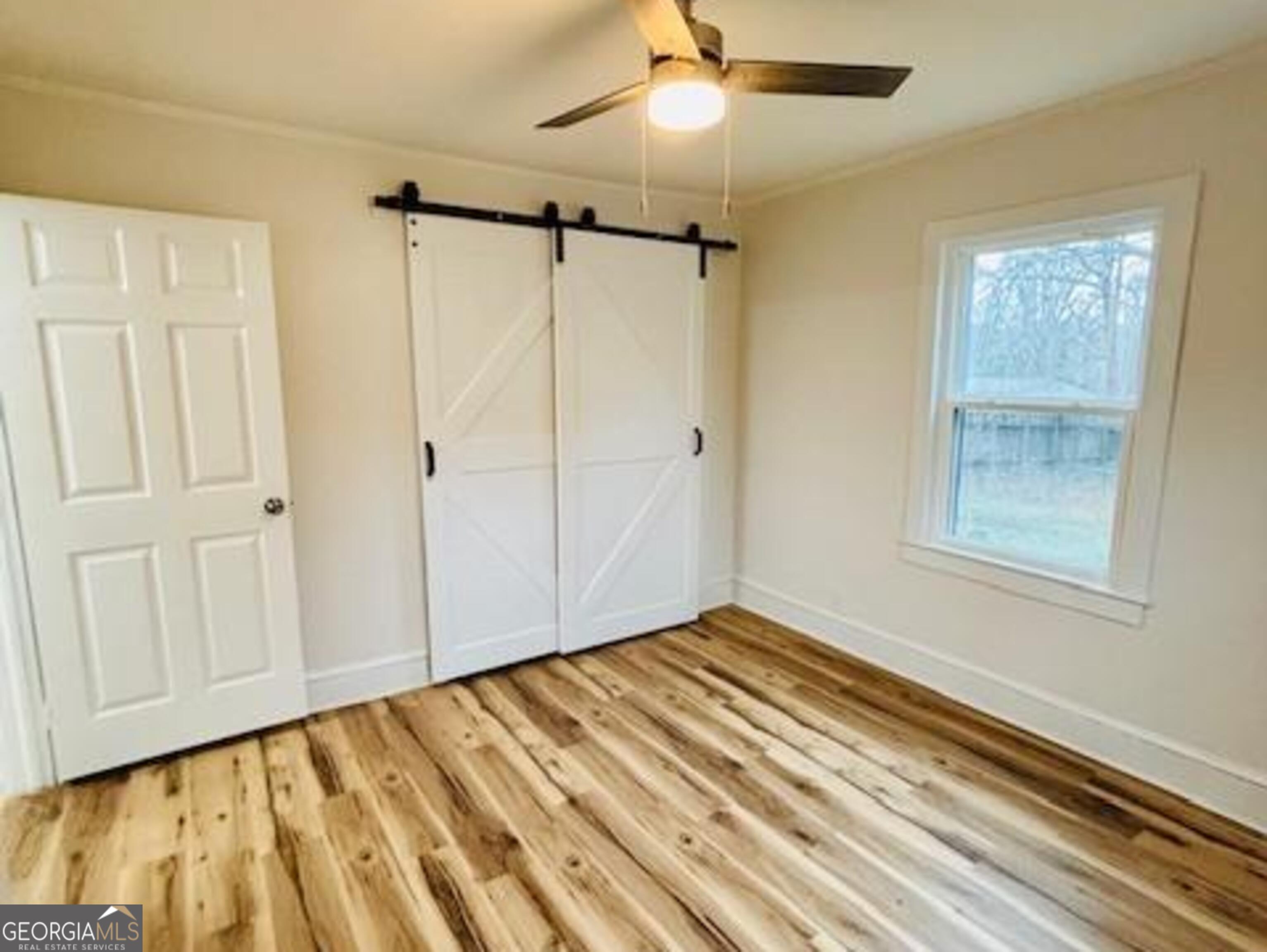 481 Collins Road Toccoa, GA 30577 - Photo 37 of 54 a view of a room with wooden floor closet and windows